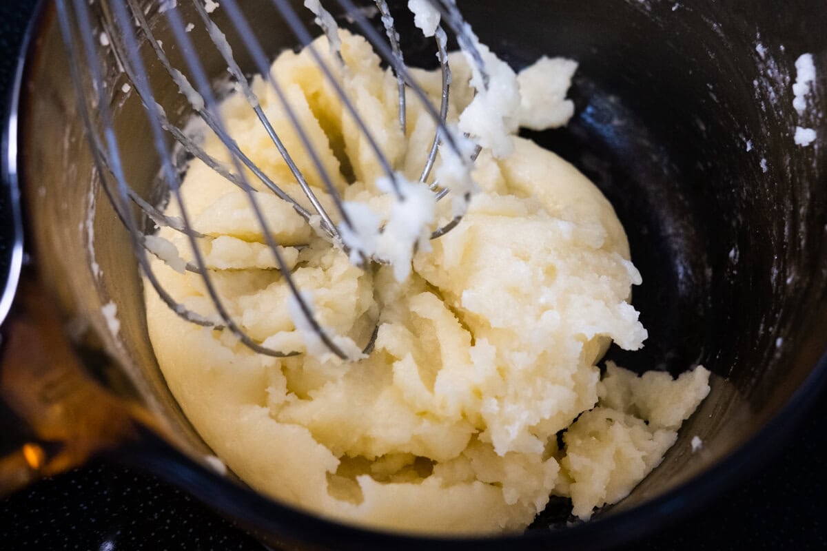 Add the flour into the saucepan and whisk together with the butter mixture. 