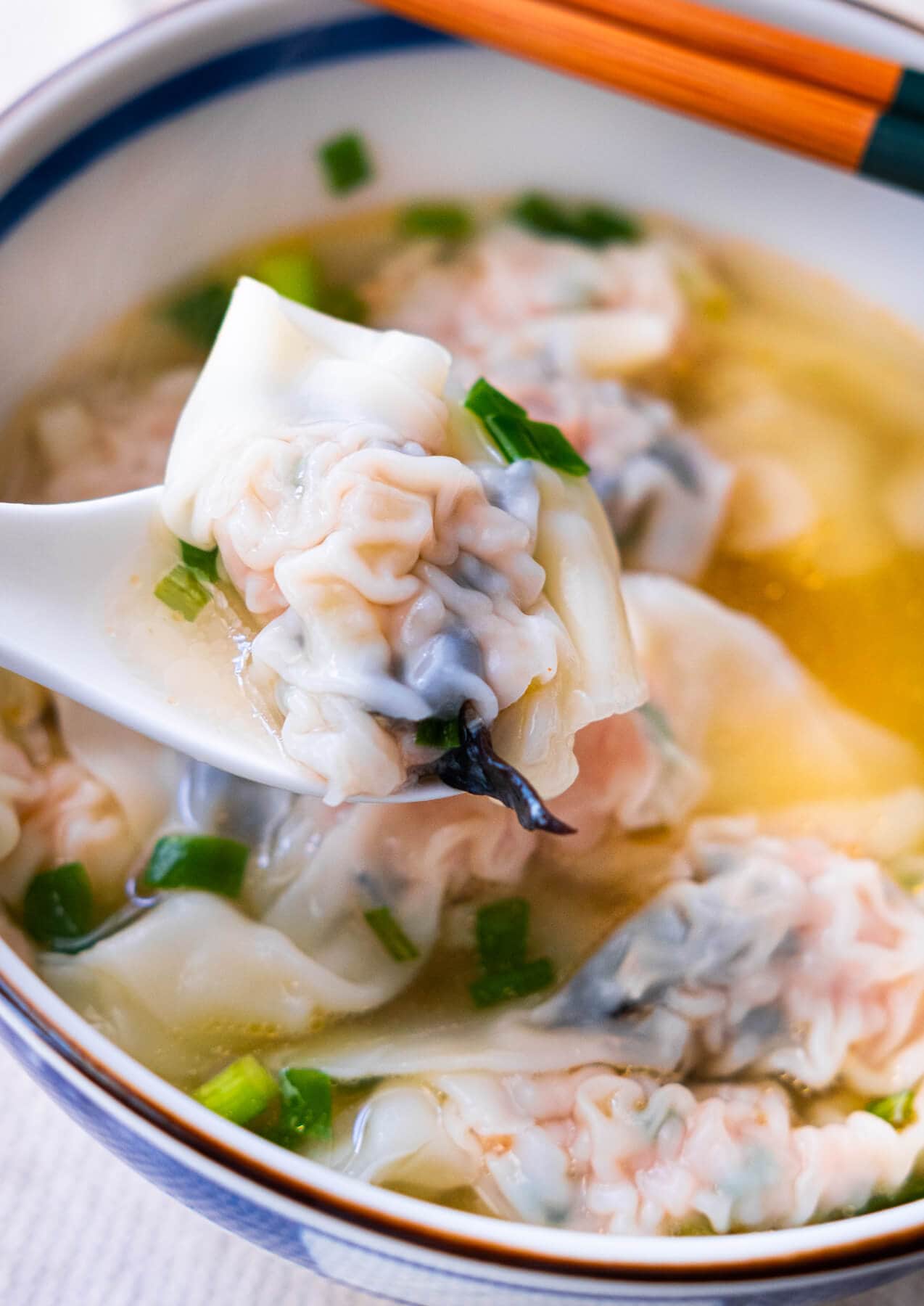 Chinese pork dumpling on a spoon. 