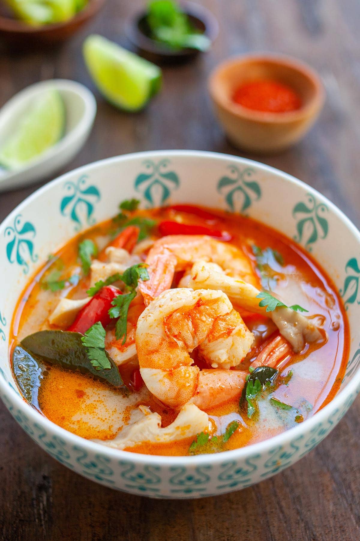 Top down view of delicious Tom Yum Soup with shrimp and mushroom, a delicious Thai recipe, laid in a bowl.