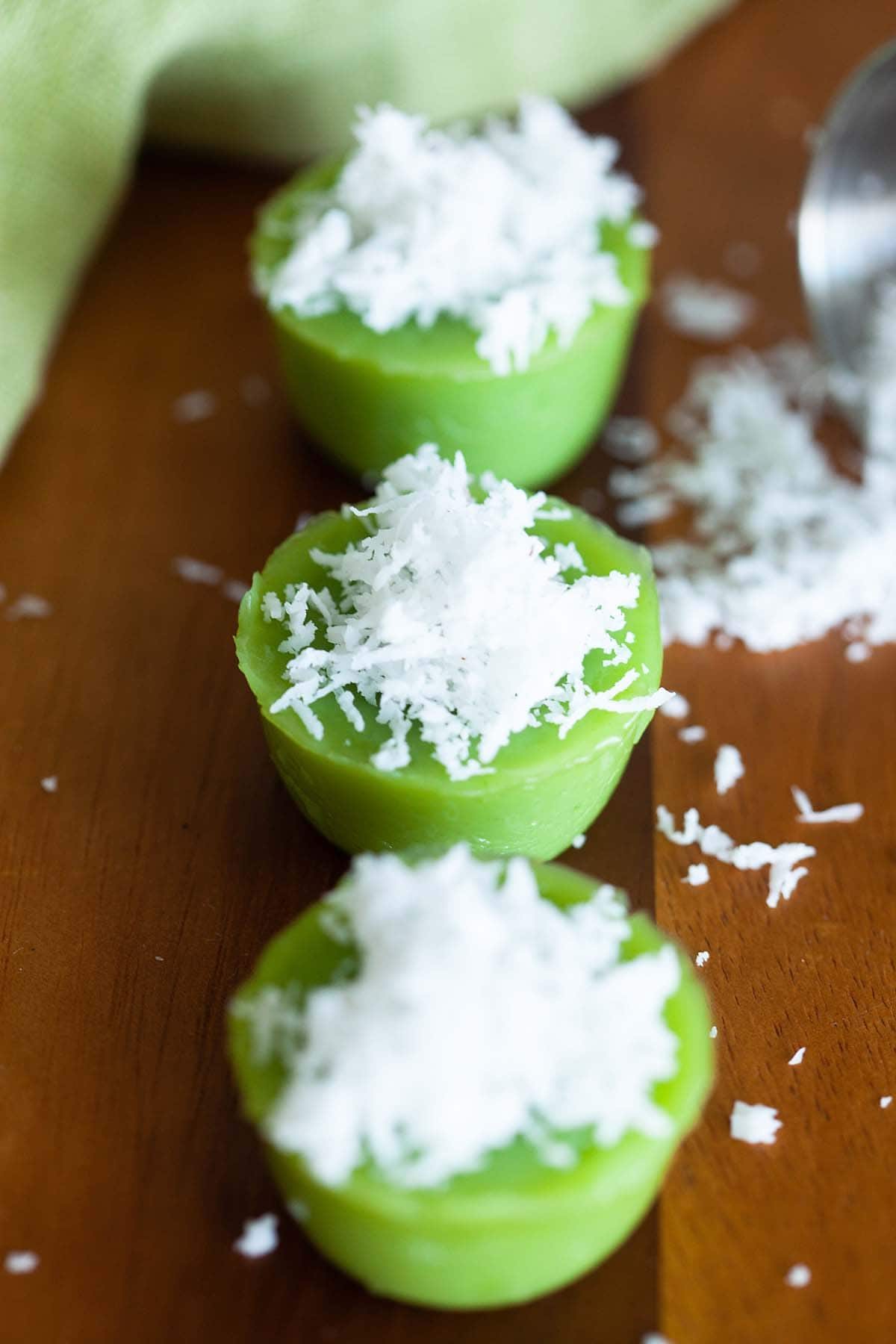 Kuih kosui saucer shaped rice cake flavored with pandan juice.