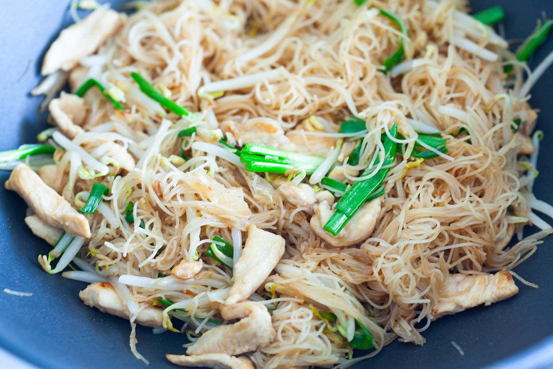 Rice vermicelli, stir-fried in a skillet.