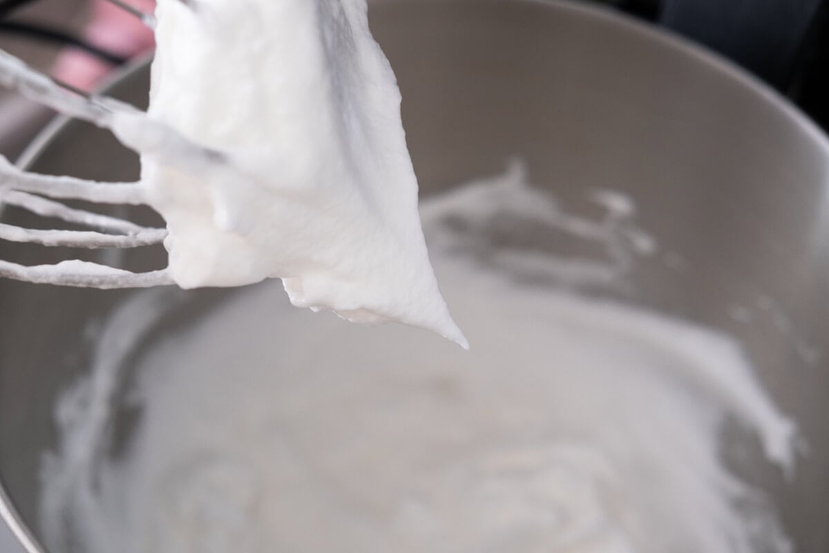 Beat the egg whites with a stander mixer until soft peaks form. 