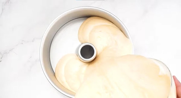 Pour the orange chiffon cake batter into a tube pan.