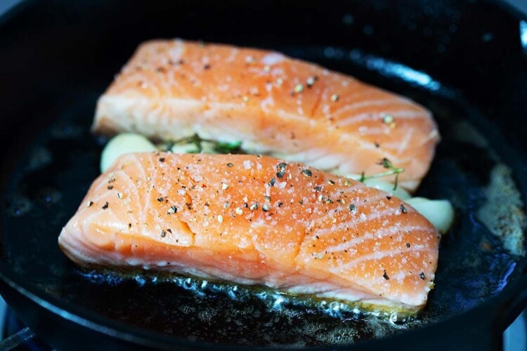 Pan seared salmon in a cast-icon skillet.
