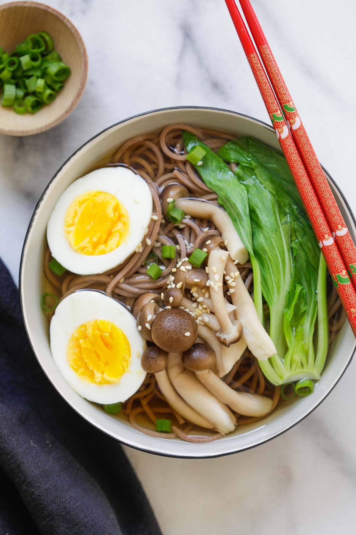 Quick and easy Japanese soba noodle soup with boiled eggs and Asian greens in a bowl.