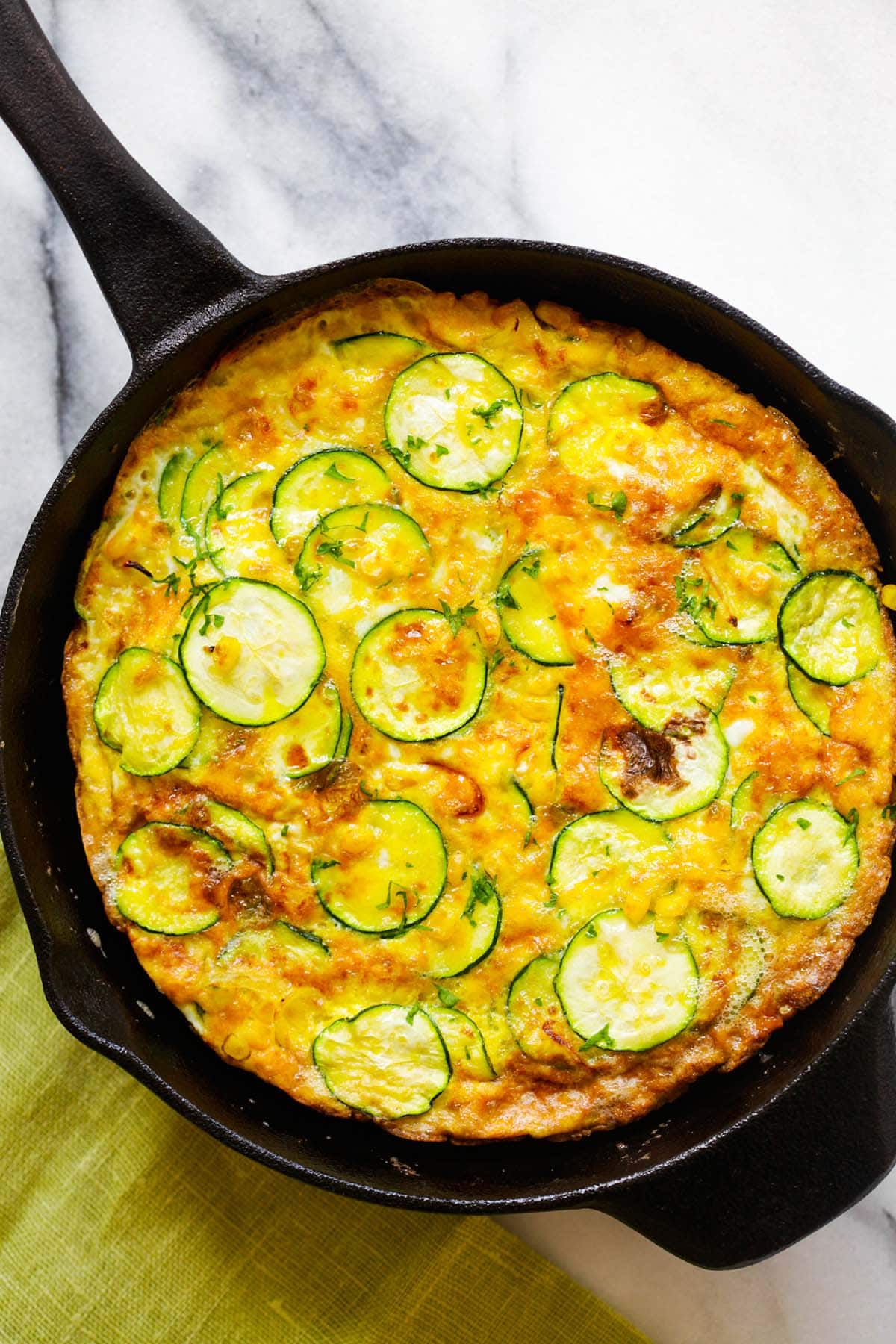 Easy and quick frittata made with zucchini and corn in a skillet.