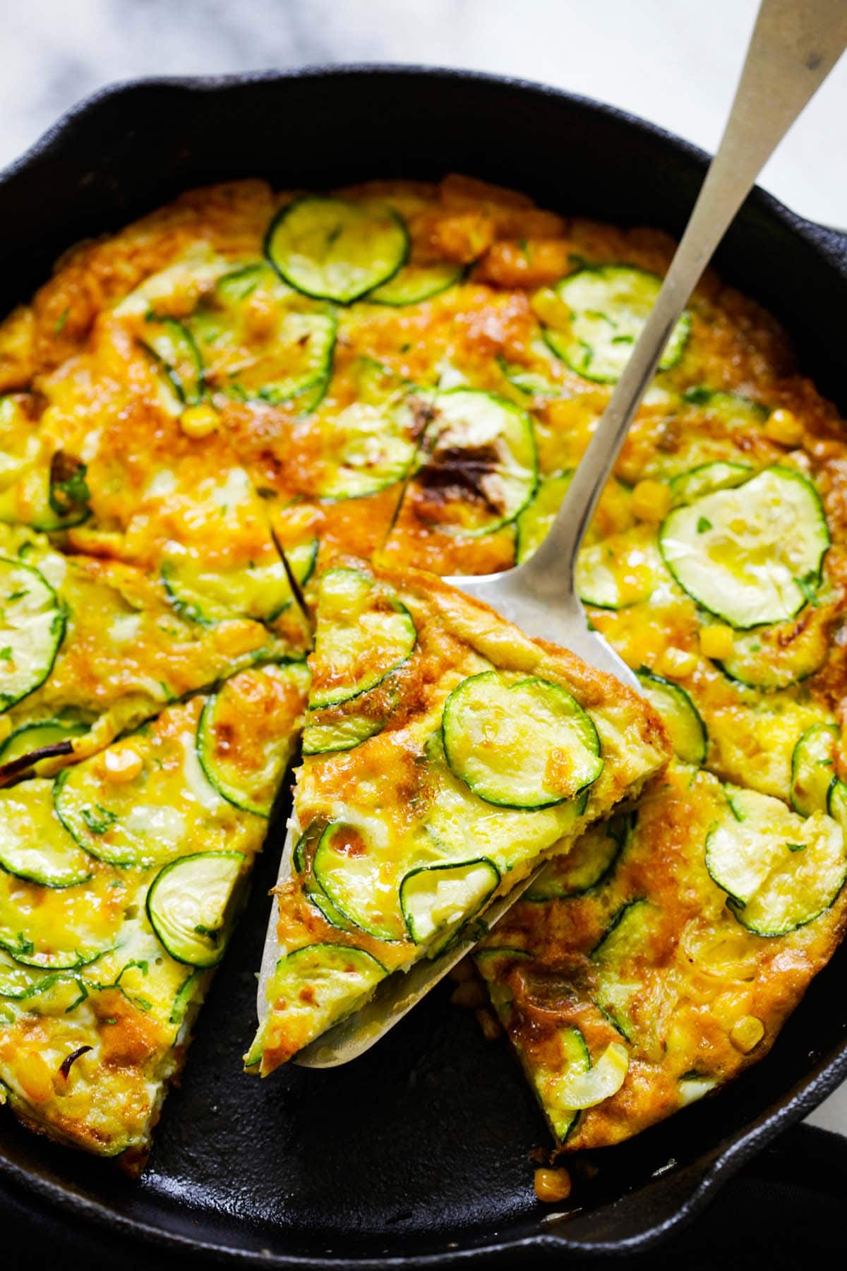 Delicious Italian omelette pancake or egg frittata with zucchini and corn.