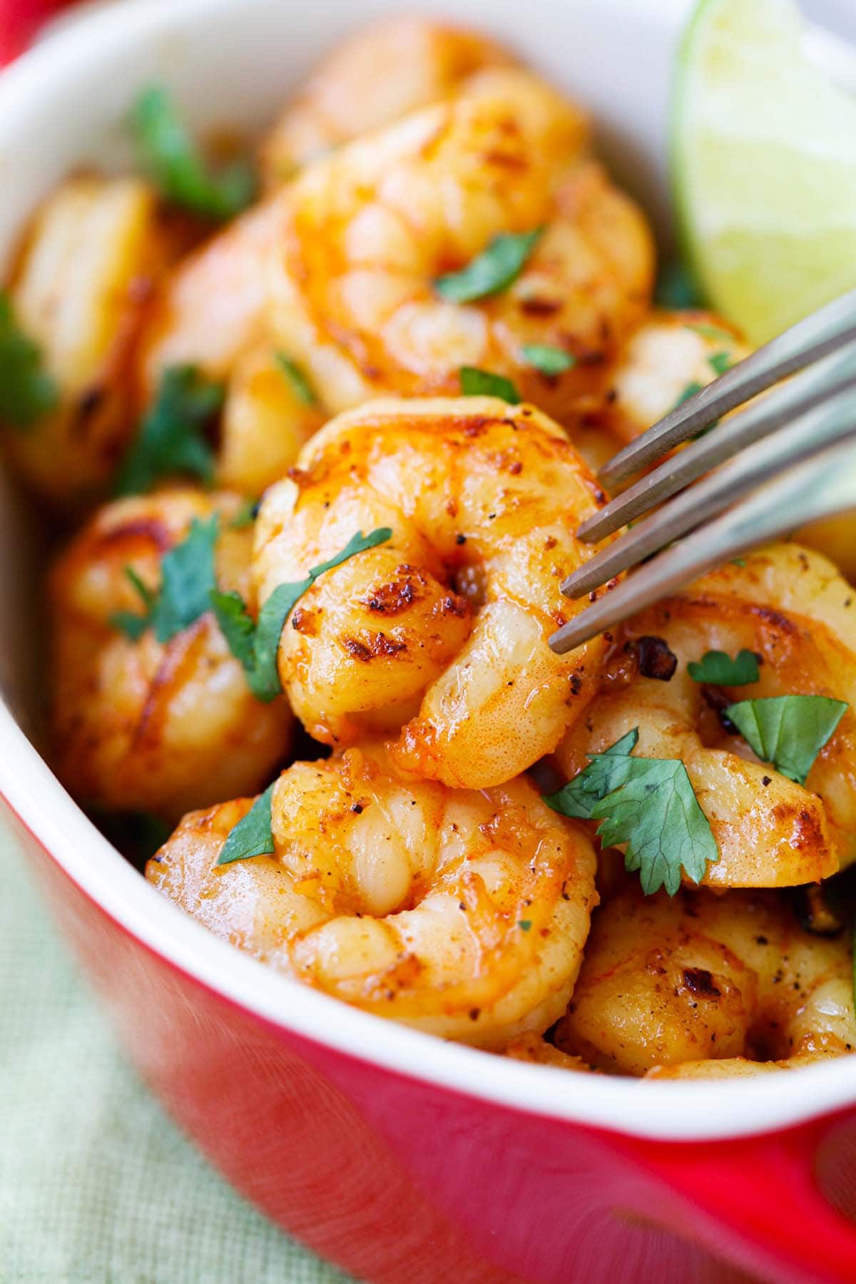 Easy and quick shrimp with tequila, lime, cilantro with a fork.