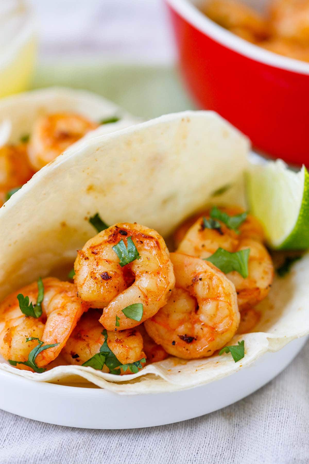 Mexican Tequila Lime Shrimp wrapped in tortillas ready to serve as tequila lime shrimp tacos.