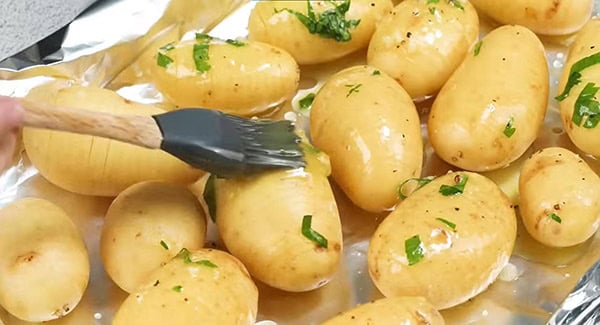 Brush the oil mixture on the potatoes. 