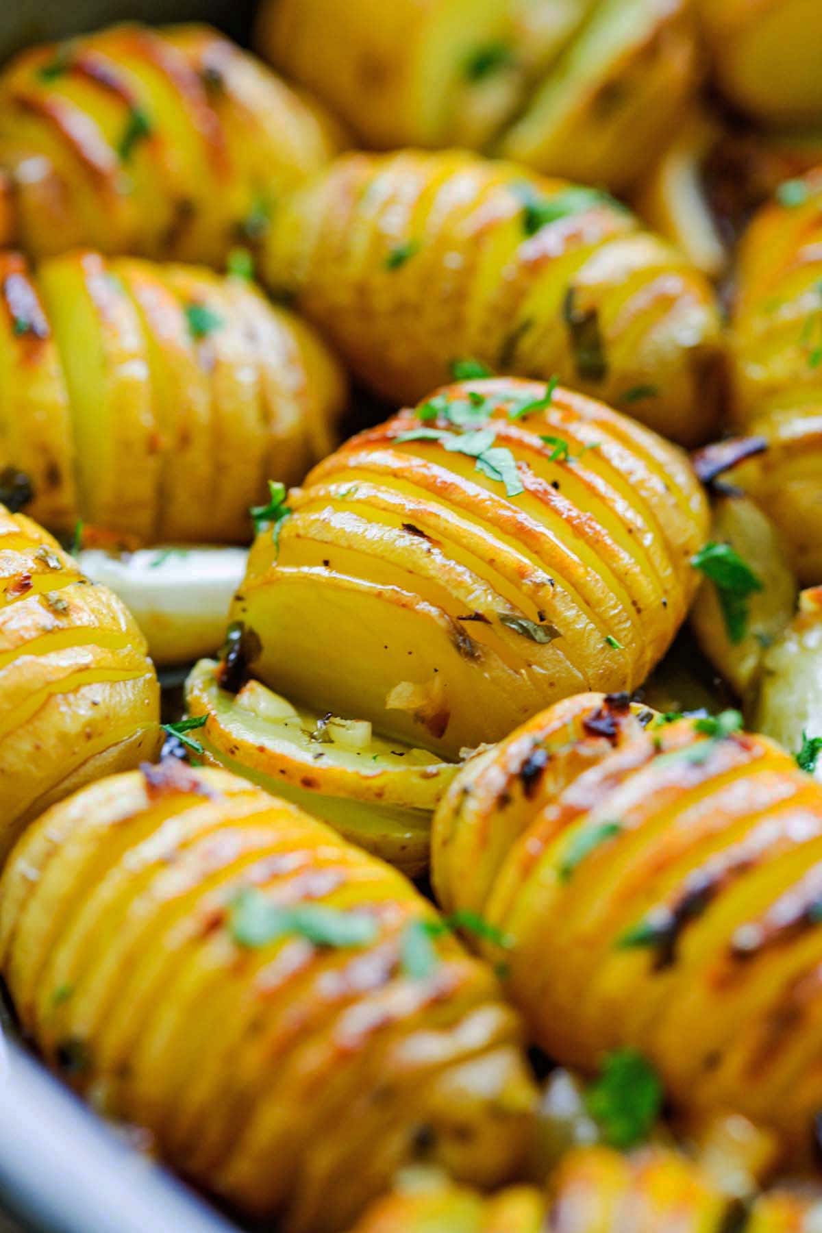 Close up shot of buttery and garlicky flavored roasted potatoes infused with flavorful herbs.
