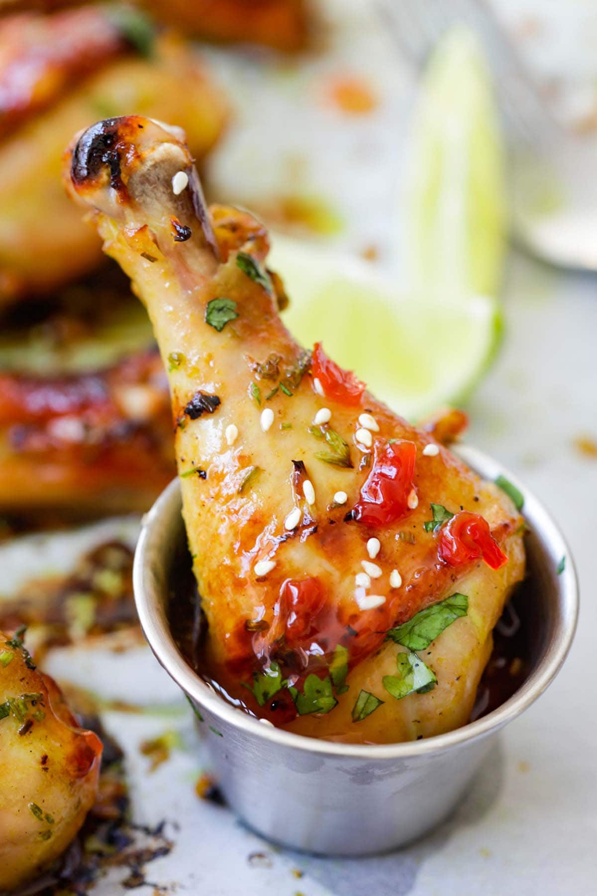 Easy and quick homemade Thai baked chicken drumsticks dipped in Thai sweet chili sauce.