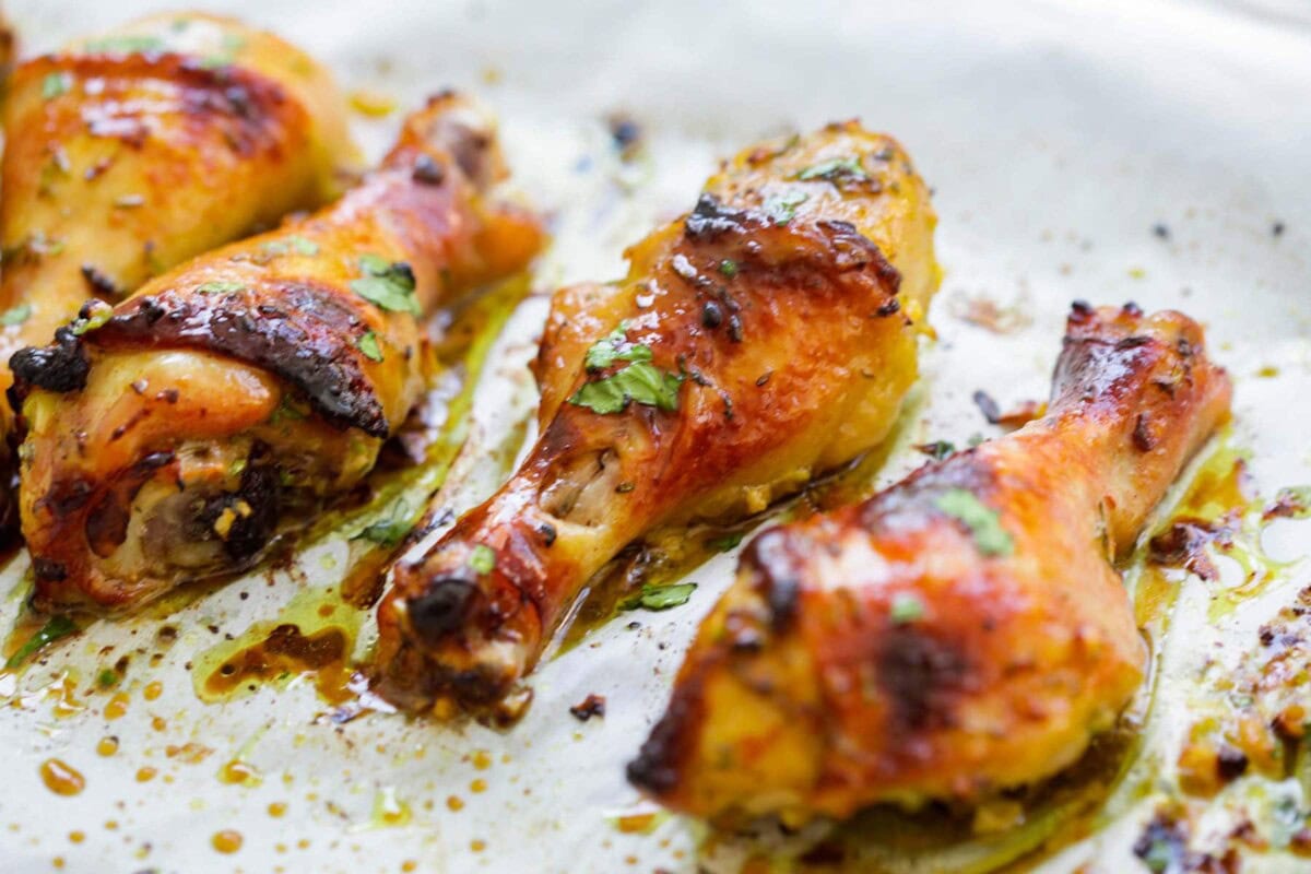 Oven baked Thai chicken legs topped with fresh cilantro.