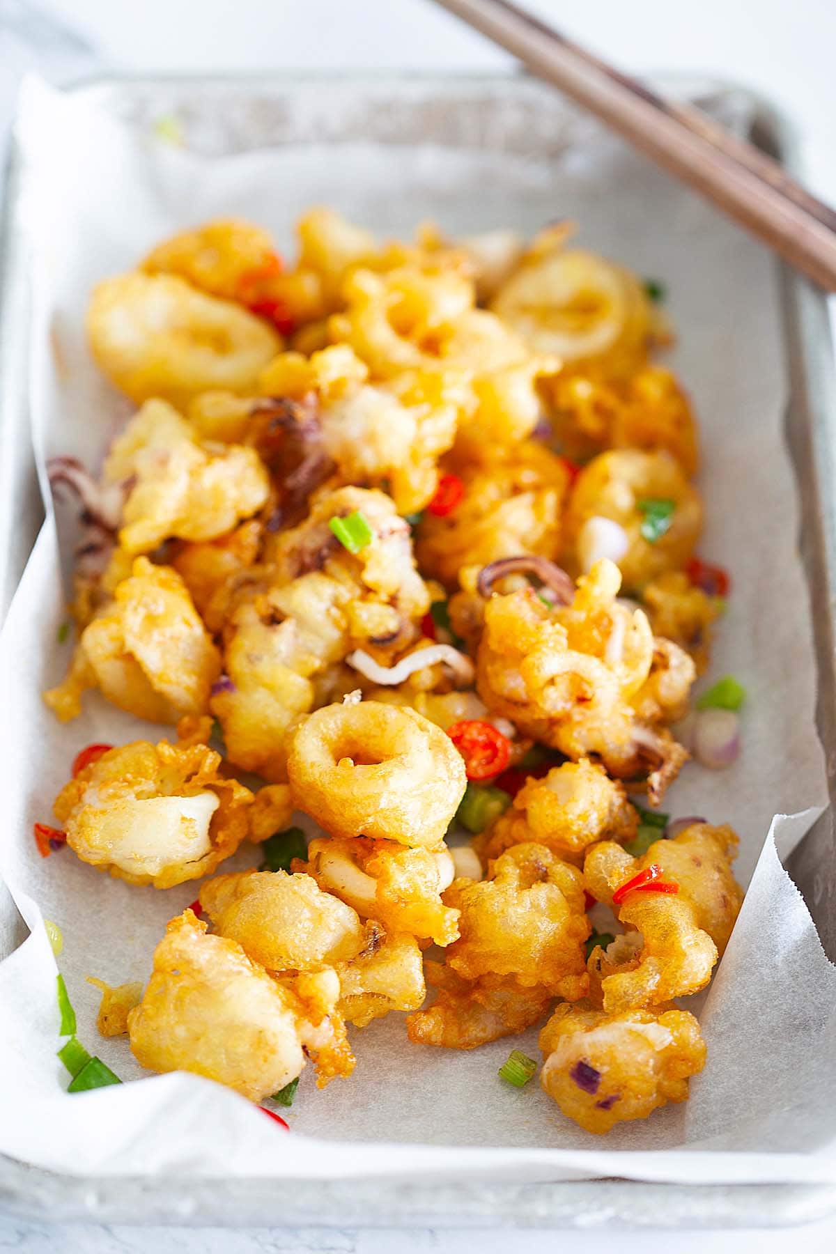 Fried squid with salt, pepper, scallion and red chilies.