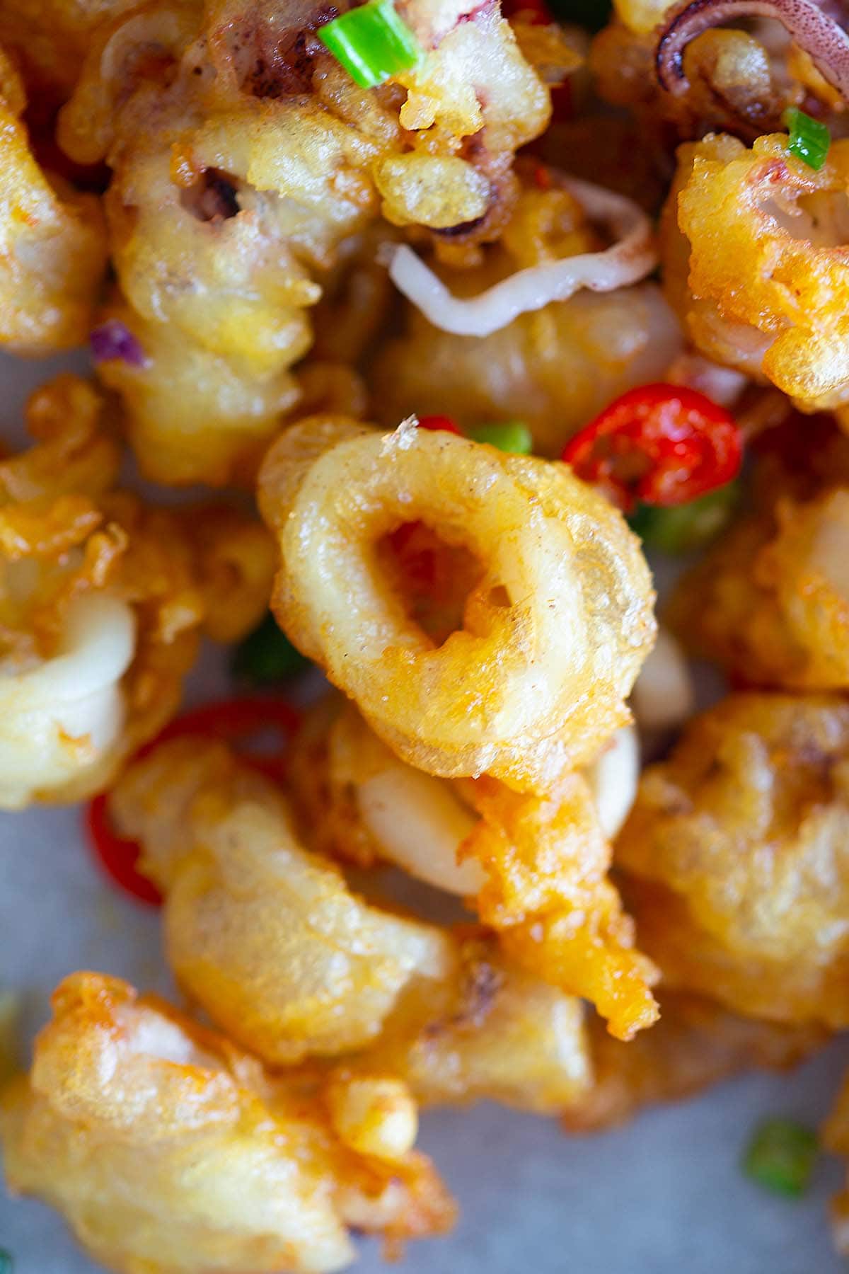 Close up shot of golden-brown crispy fried squids. 