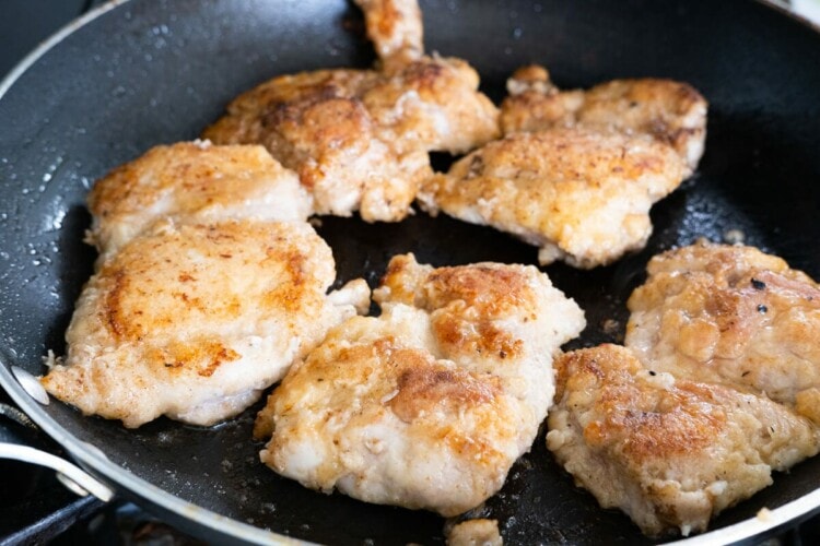Pan-frying floured chicken thighs for making chicken marsala