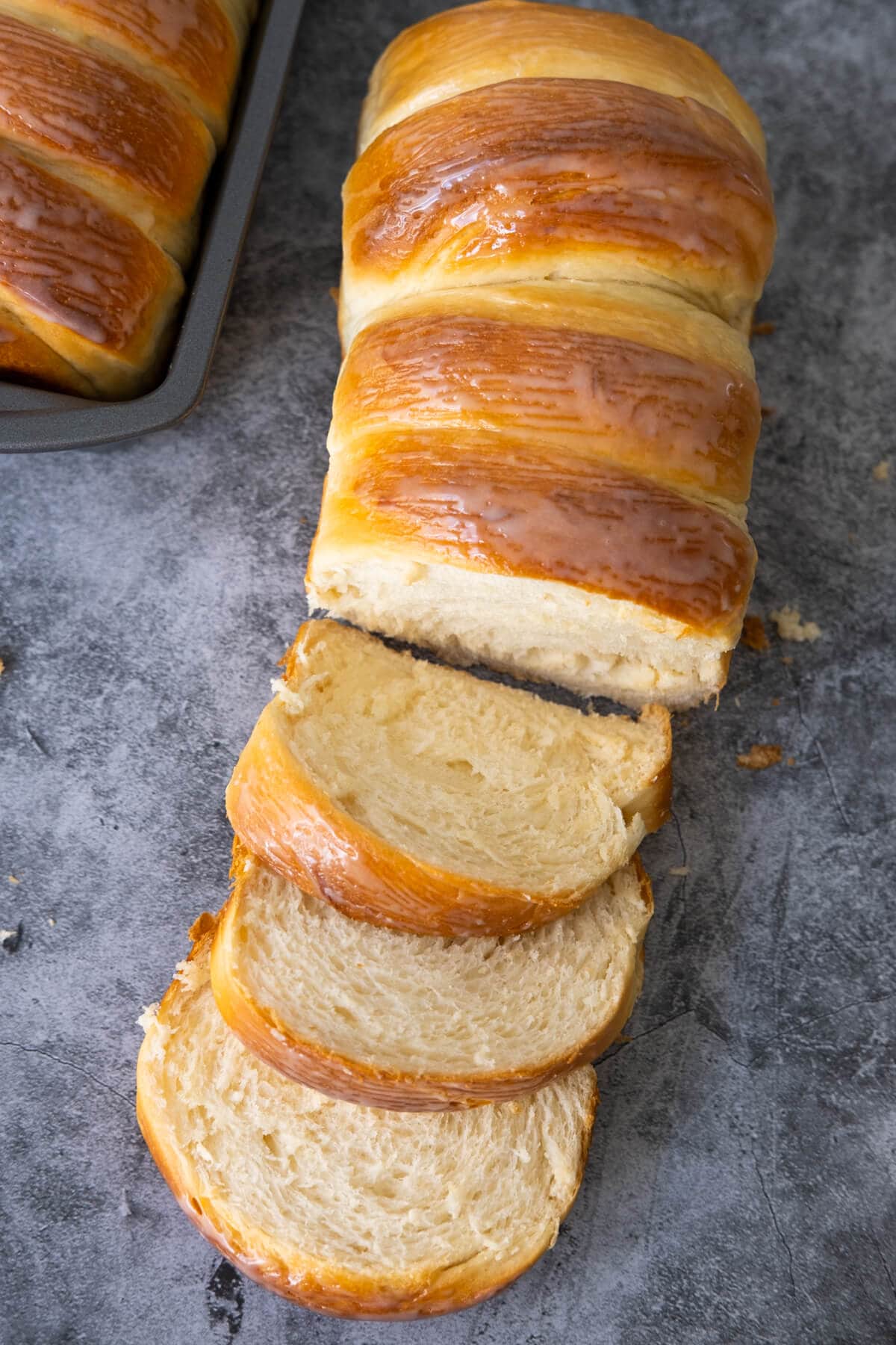 A loaf of condensed milk bread with slices of it cut off. 