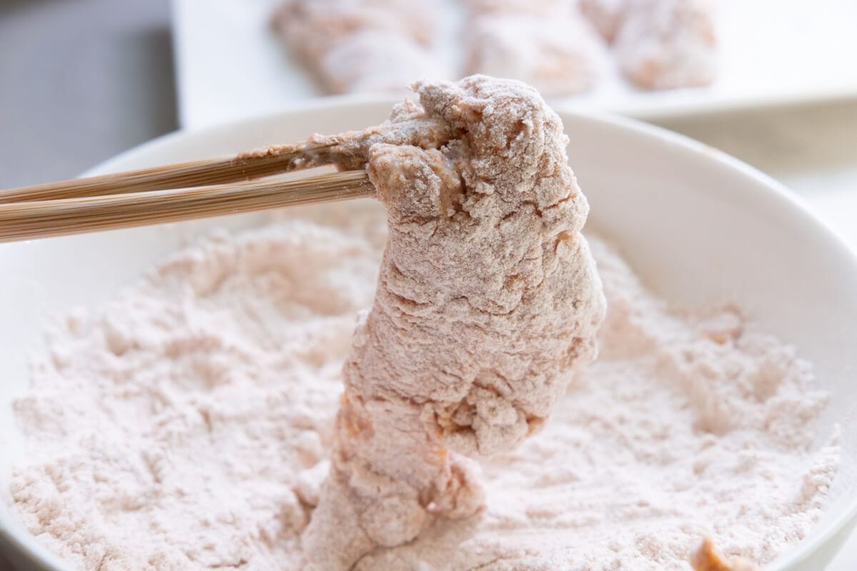 Coating Nashville chicken tenders with flour before deep frying