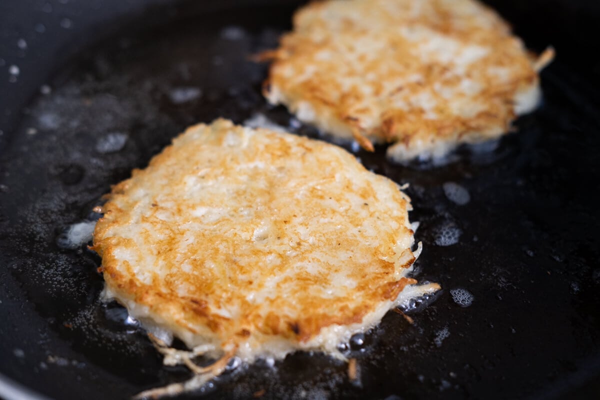 Fry both sides of the potato pancakes until golden brown.