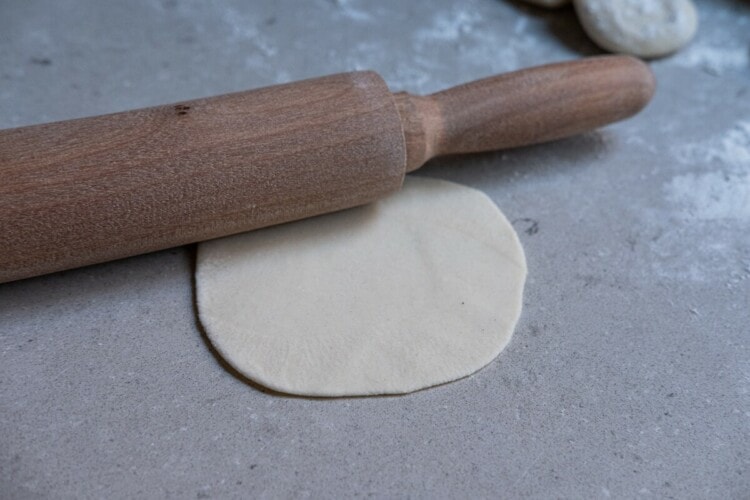 Shape and flatten the wrapper with a rolling pin