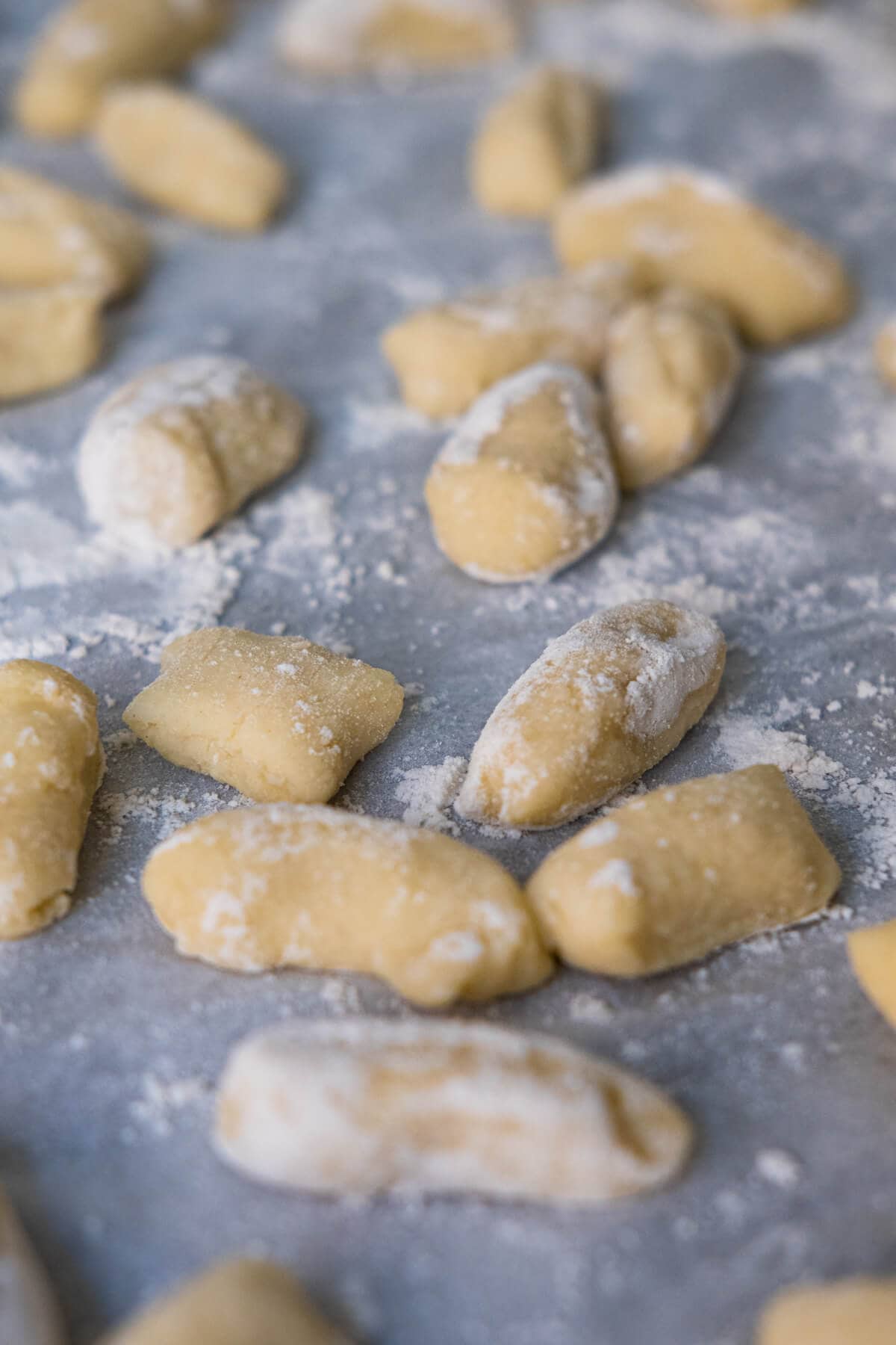 Potato gnocchi on kitchen countertop.