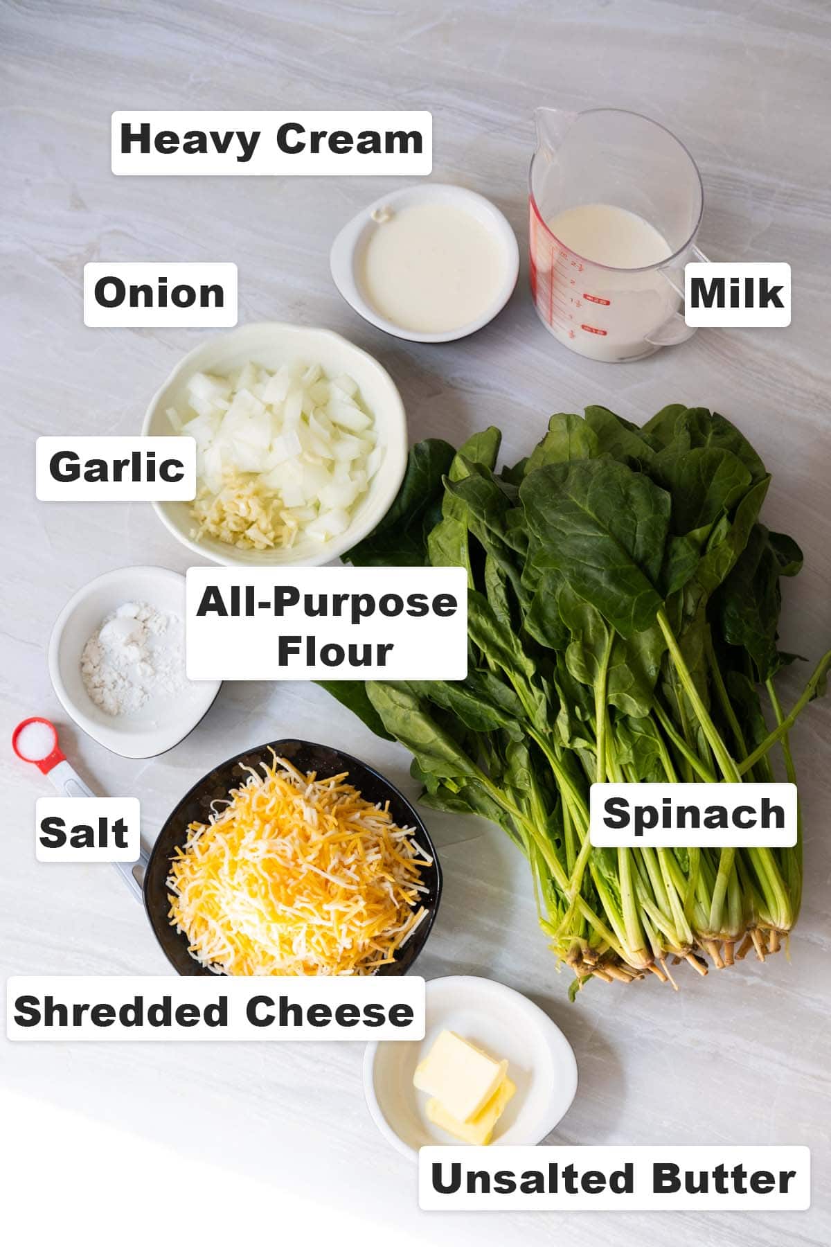 All ingredients placed on a table for creamed spinach recipe