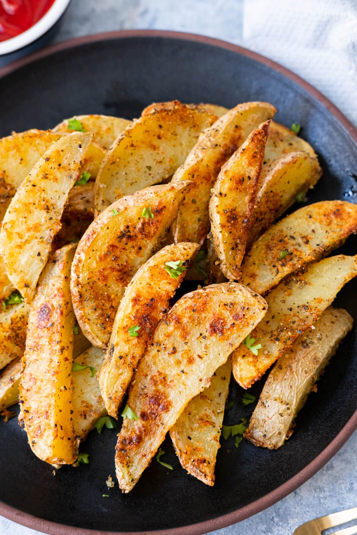 Crispy garlic parmesan potato wedges served with ketchup on the side. 