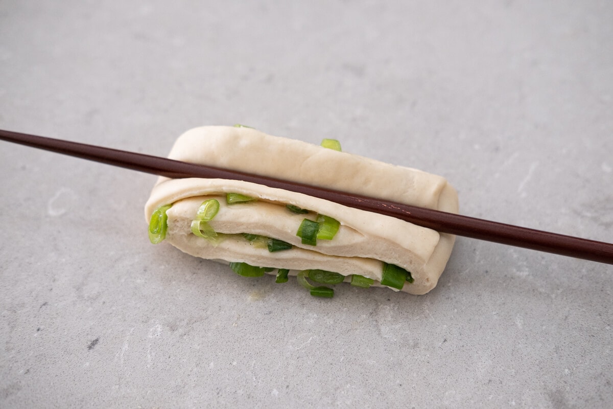 Press the dough down in the middle with a chopstick.