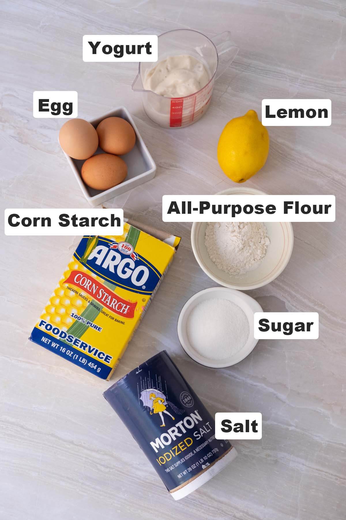 Yogurt cake ingredients: yogurt, egg, lemon, all-purpose flour, corn starch, salt and sugar. 