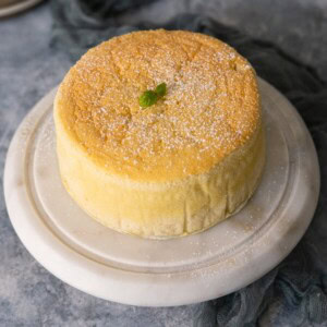 Yogurt cake on a marble cake stand.