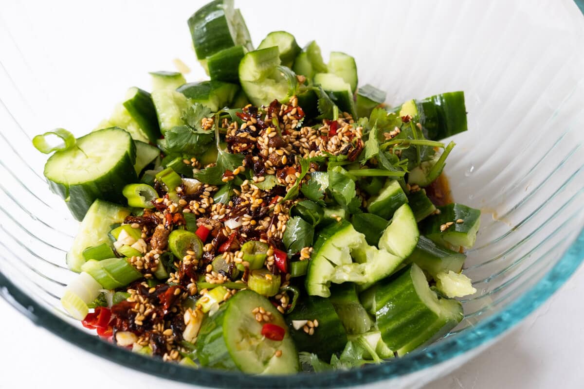 Combine other ingredients with smashed cucumber pieces and toss with dressing. 