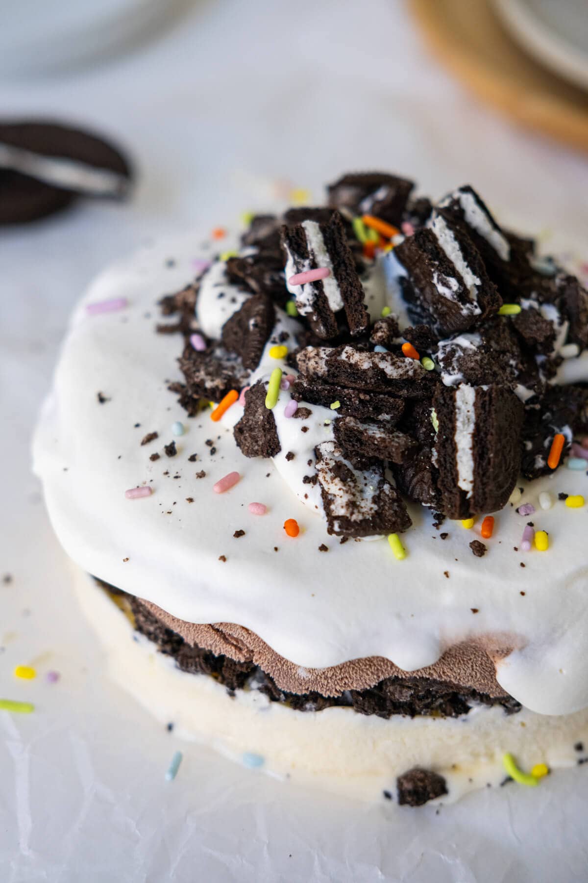 Ice cream cake with Oreo crumbs and sprinkles on top.