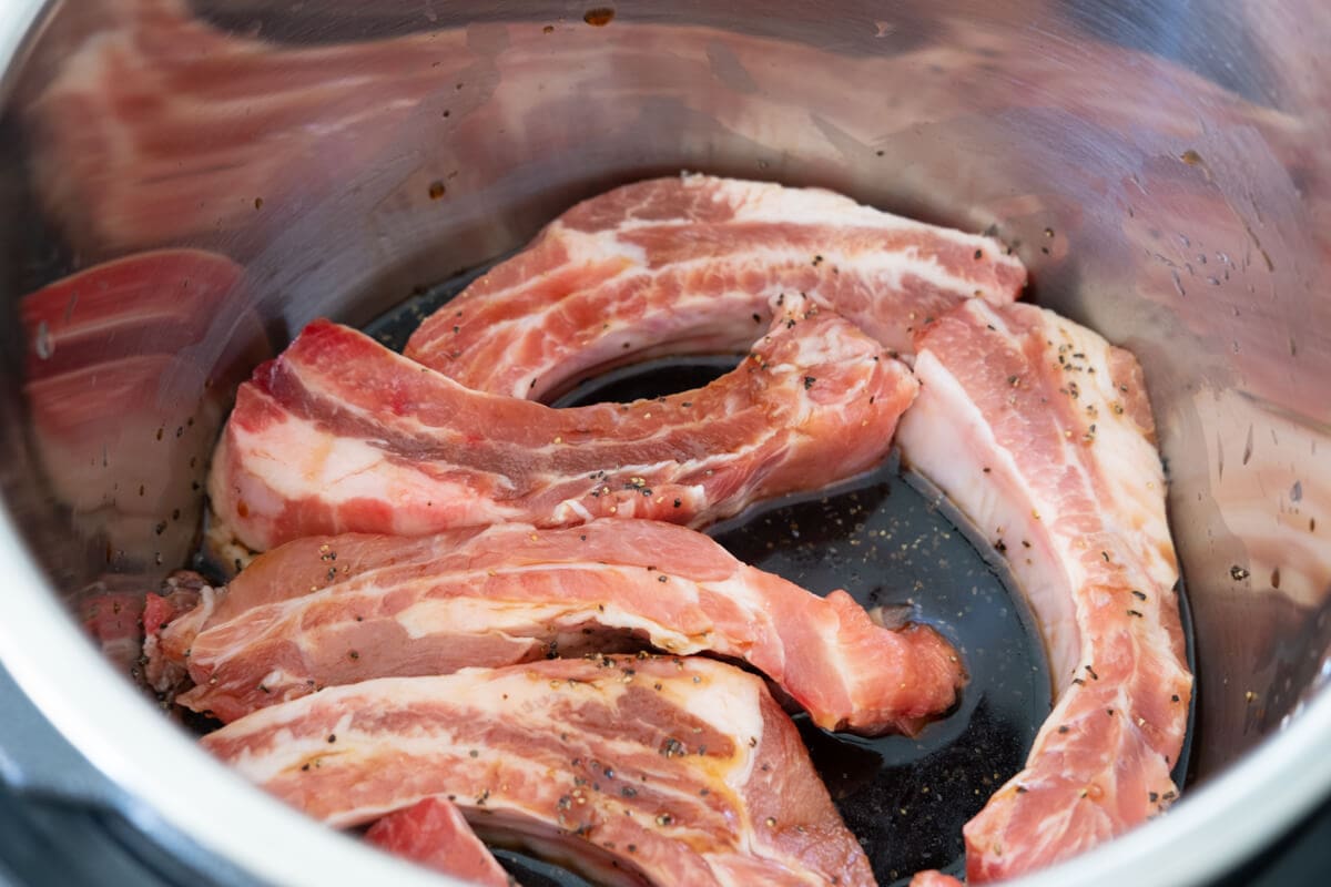 Place baby ribs in the slow cooker and add teriyaki sauce. 