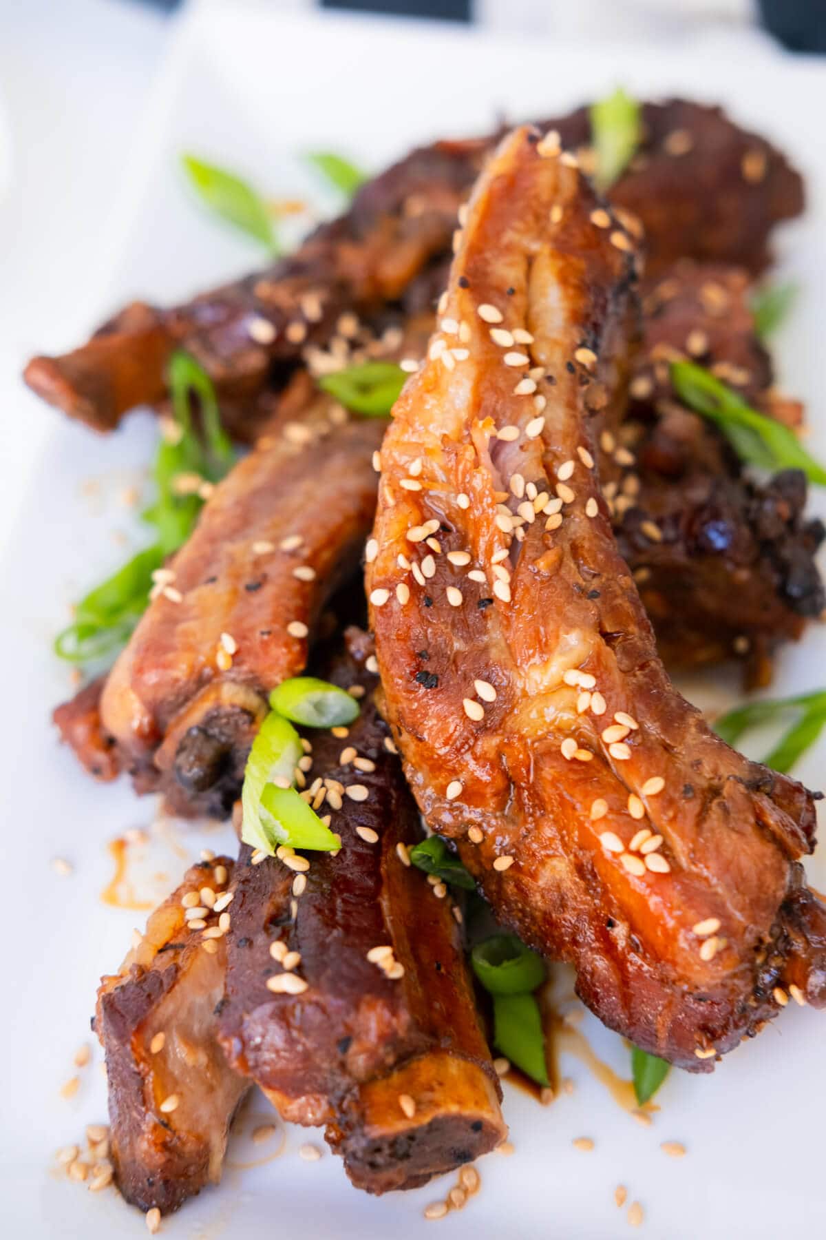 Tender and juicy slow cooker teriyaki ribs served on a white plate. 