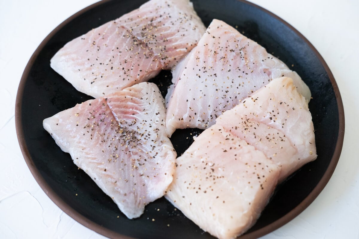 Season catfish fillets with salt and pepper.