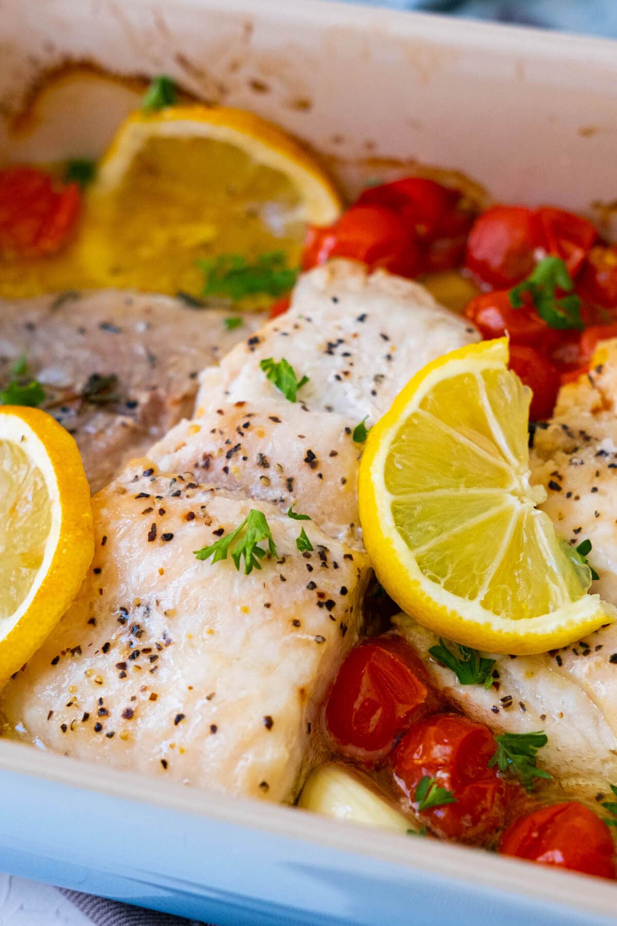 Baked catfish with lemon slices on top. 