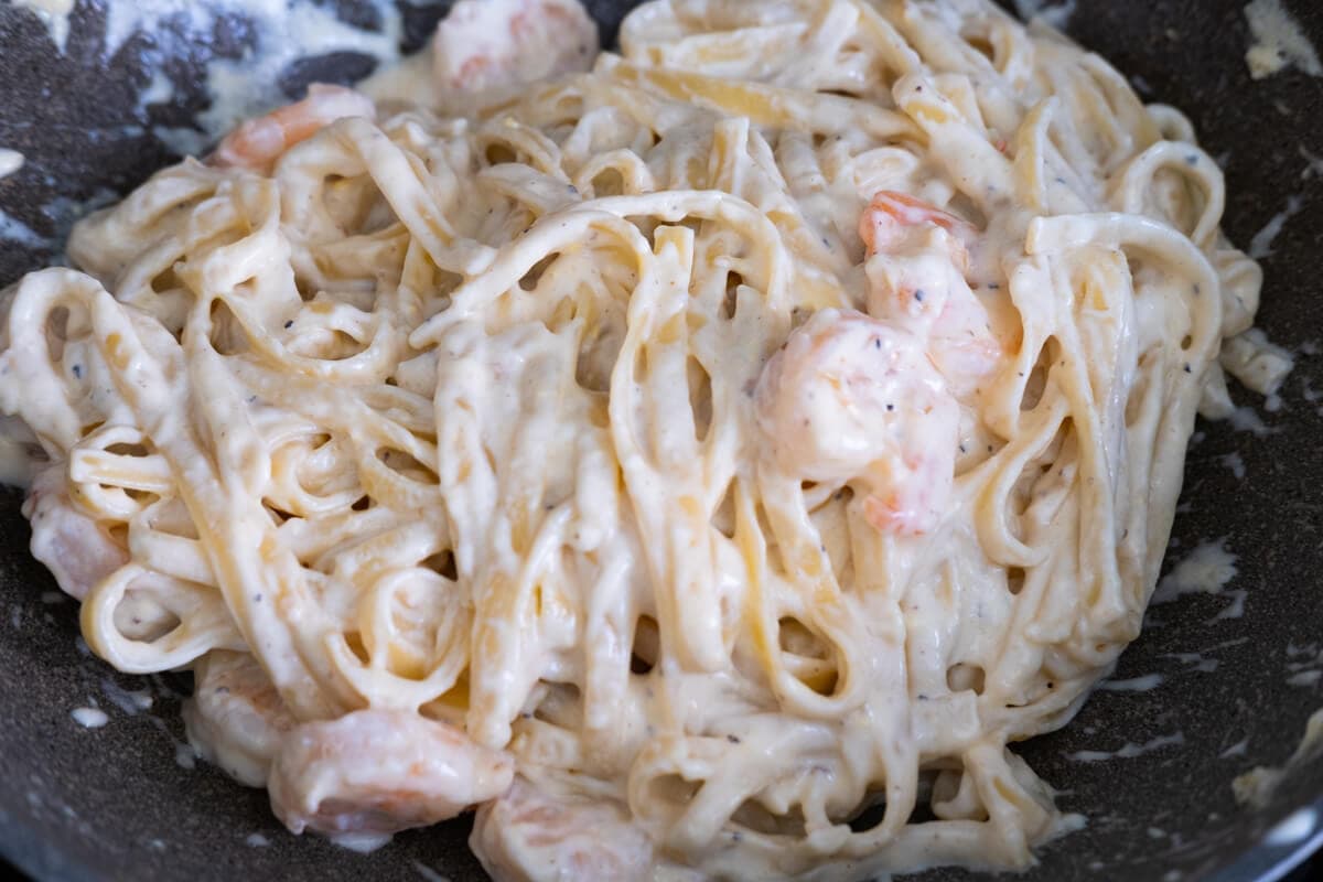 Add cooked fettuccine and shrimp to creamy sauce and stir to combine well. 