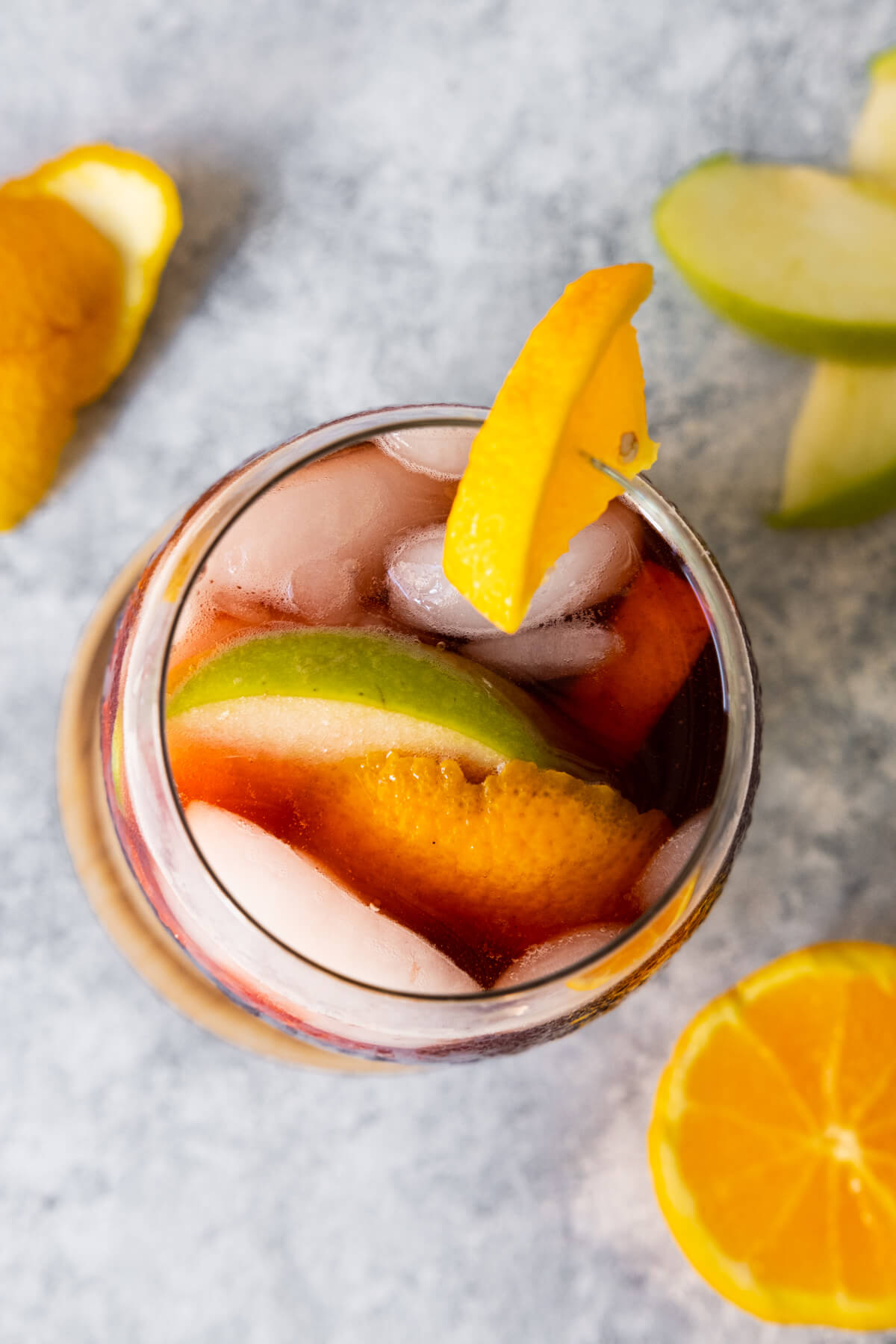 Top down view of Spanish Sangria in a glass with apple and orange slices.