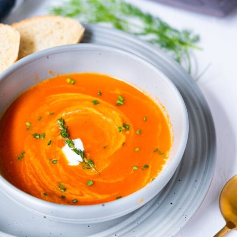 Classic tomato soup served with French cream, fresh thyme and chopped chives on top.