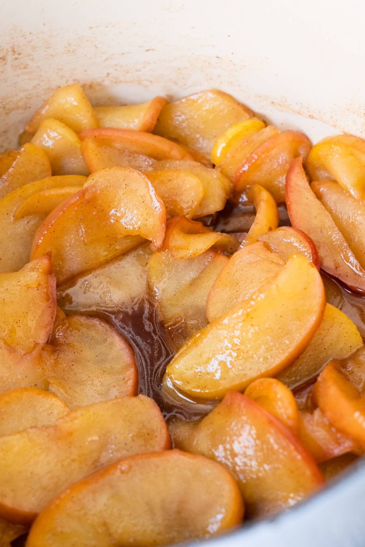 Close up shot of tender apple slices covered with cinnamon. 