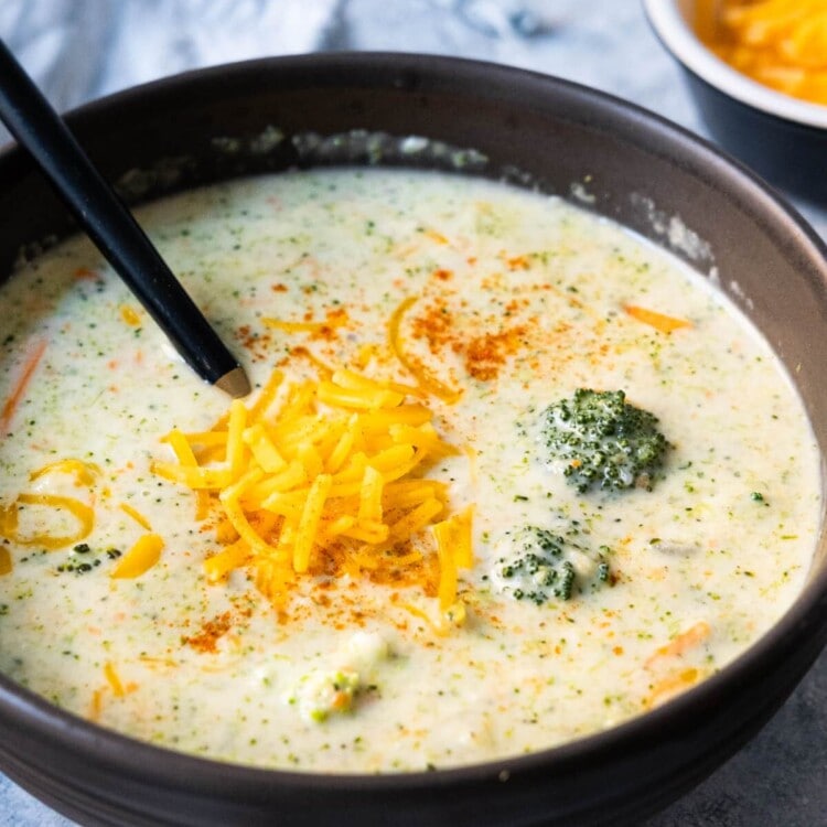 Creamy broccoli cheddar soup with extra cheddar cheese on top.