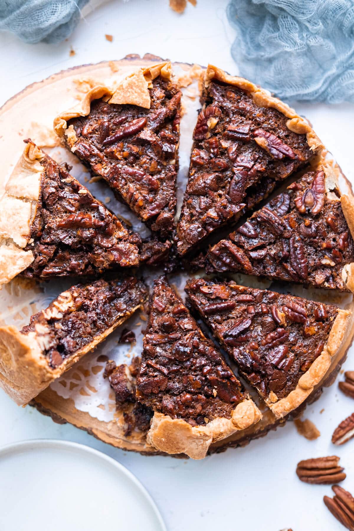 Chocolate pecan pie with crunchy pecans on the side.