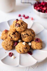 Oatmeal chocolate cranberry cookies with white chocolate chips and dried cranberries on a plate.