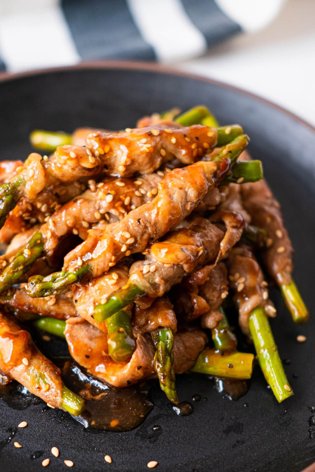Hot pork wrapped asparagus served with white sesame on top. 