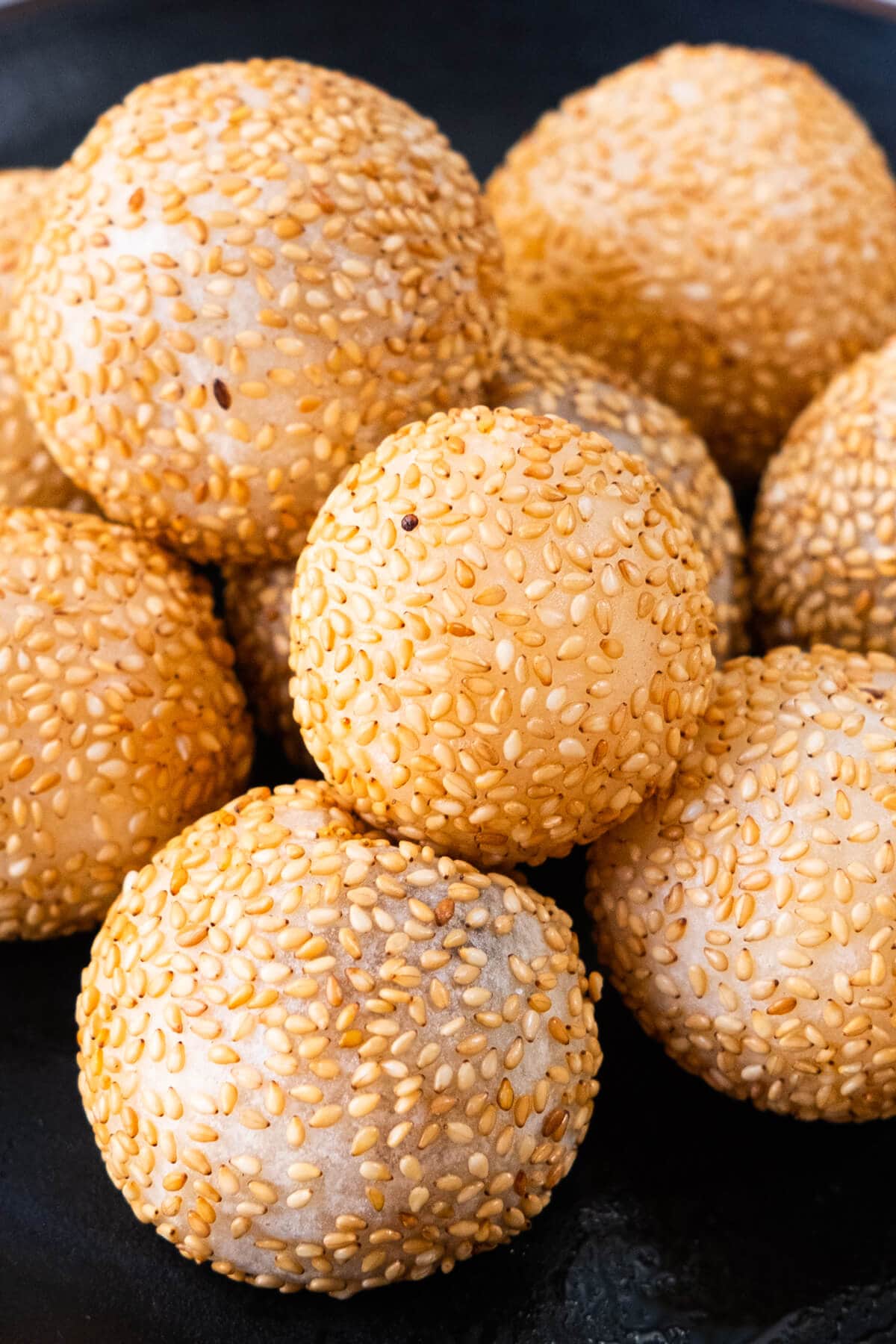 Balls of deep fried, sesame coated, and sweet red bean paste filled ball.  