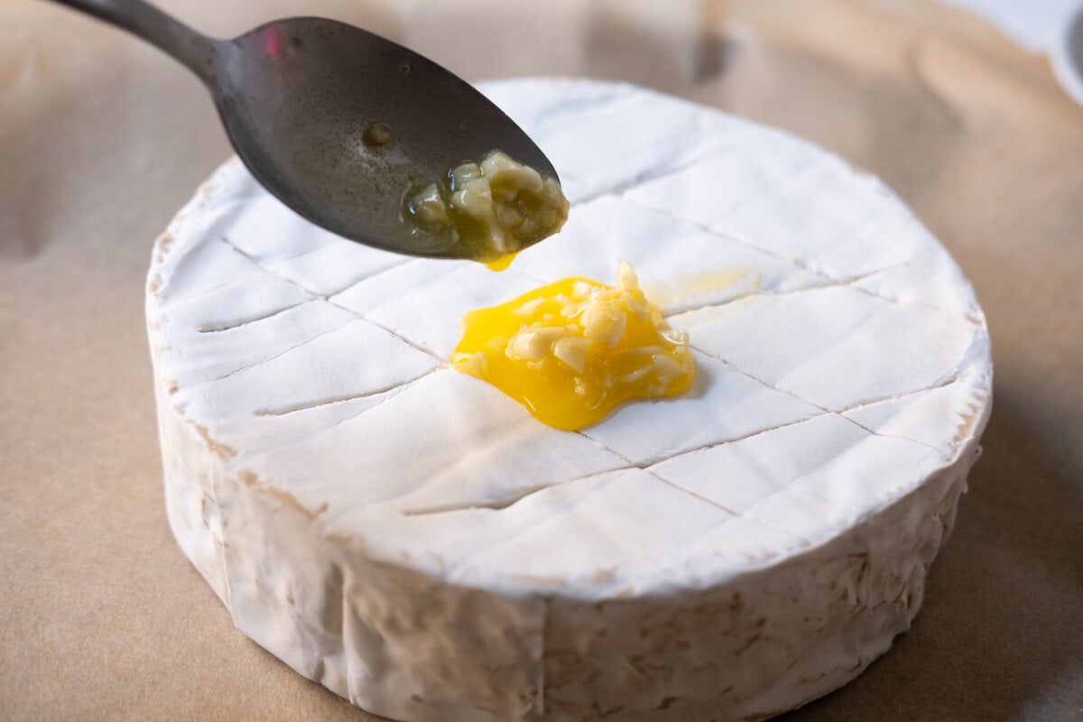 Score the top of brie with a knife. 