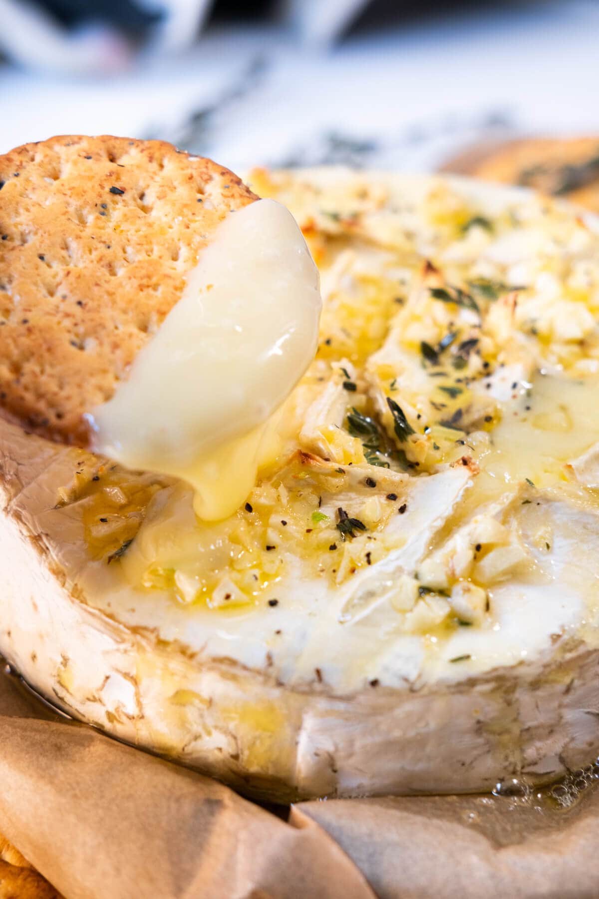 Dip into the garlic butter baked brie with a piece of cracker. 