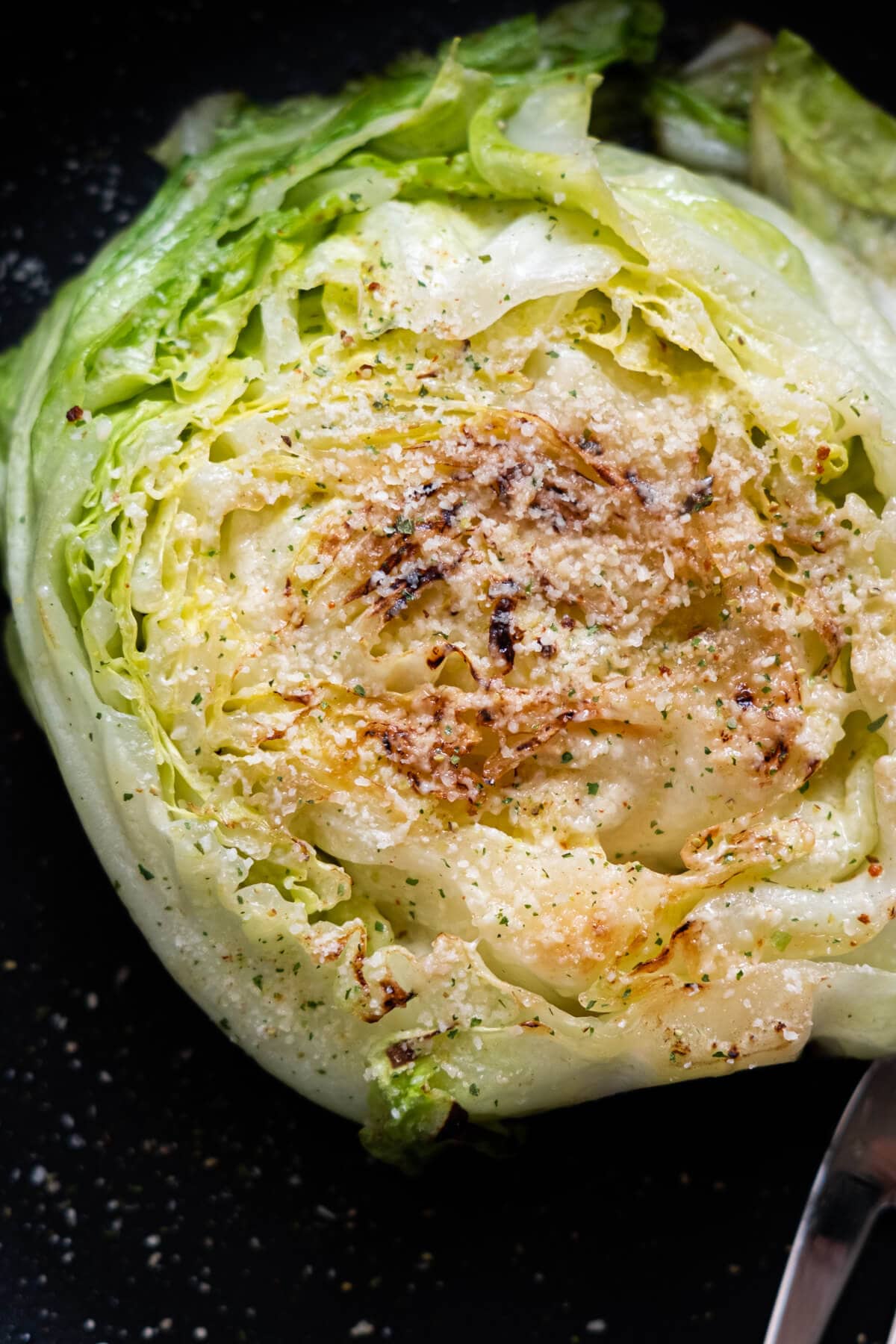 Cabbage steak with grated parmesan cheese. 