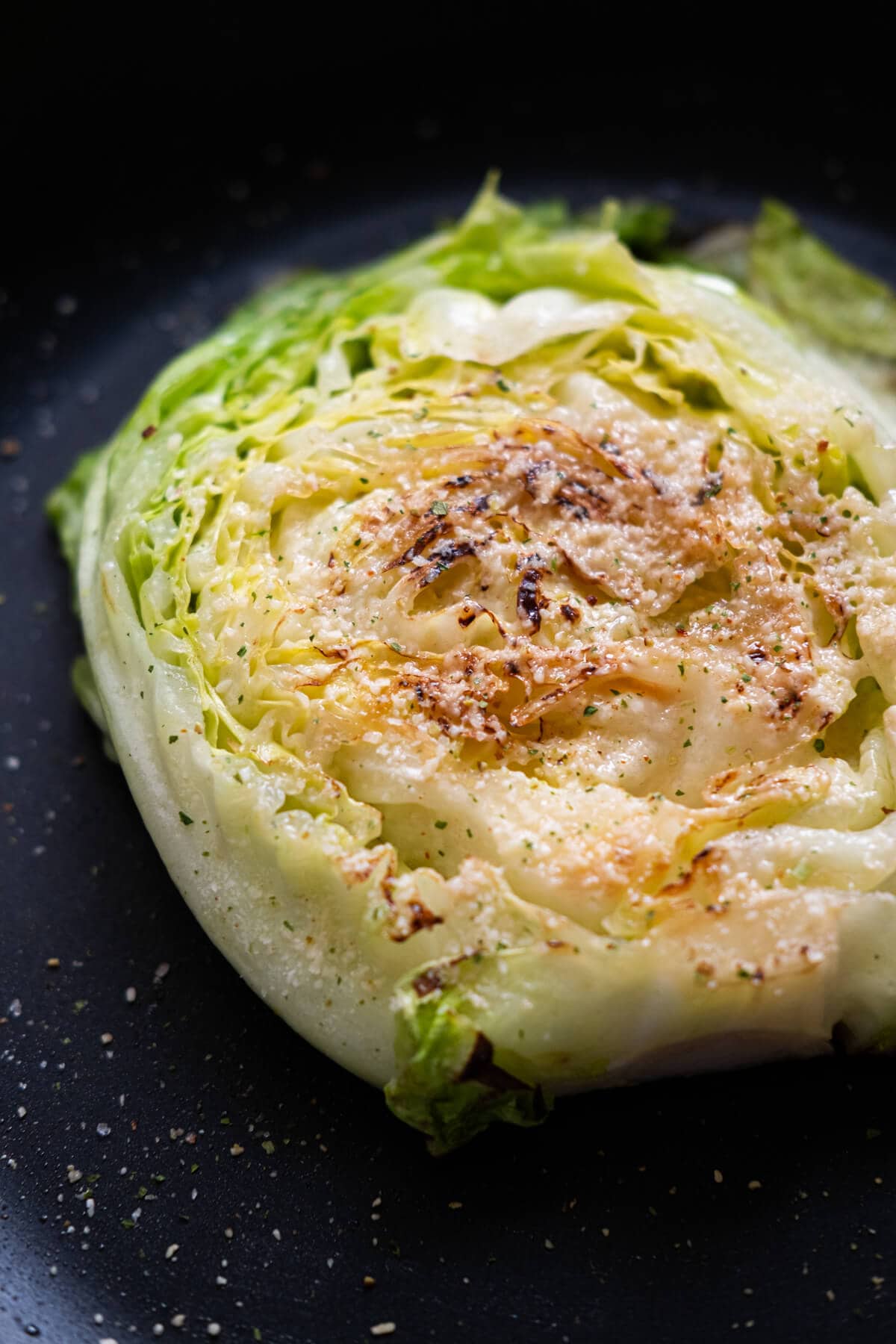 Cabbage steaks are perfectly seared in a pan. 