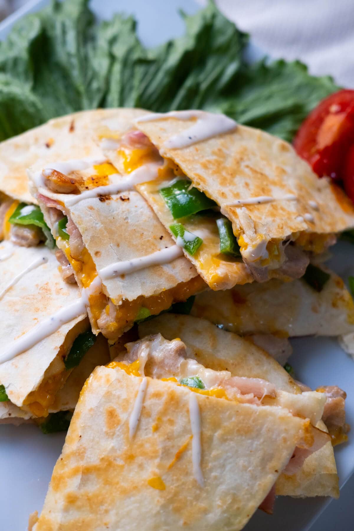 Chicken and bacon quesadilla with melty cheese, green pepper, chicken and bacon. 